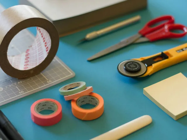 Cutting and collage tools on an artist’s work surface